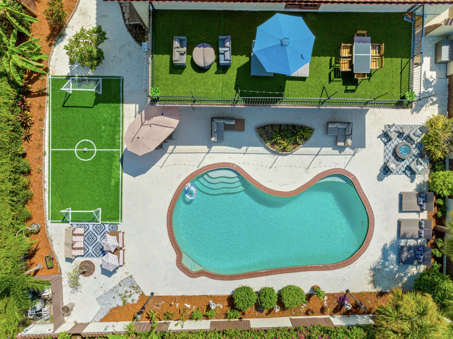 The pool, turf, and patio seating seen from directly above